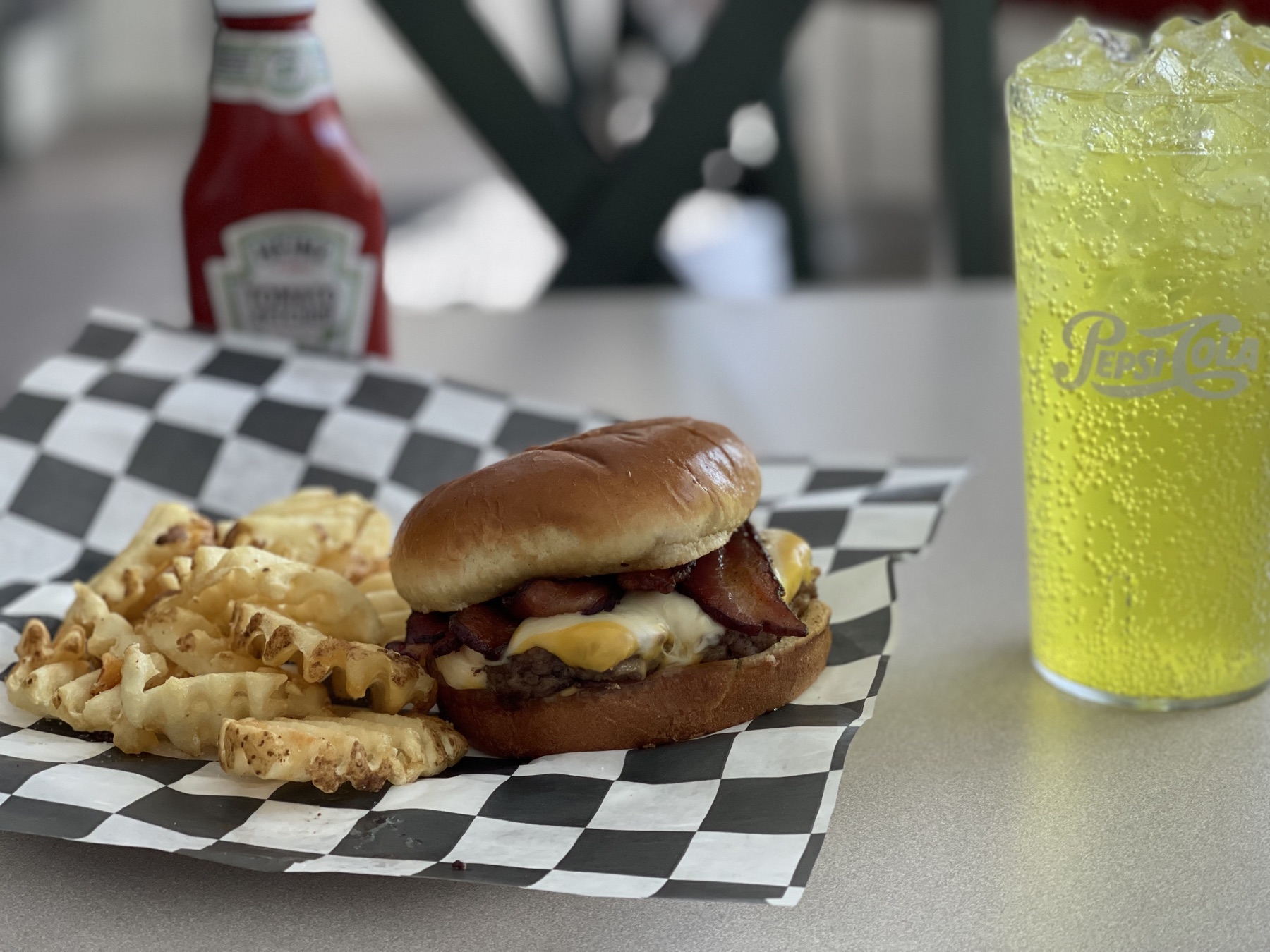 Burger, waffle fries, and a cold drink